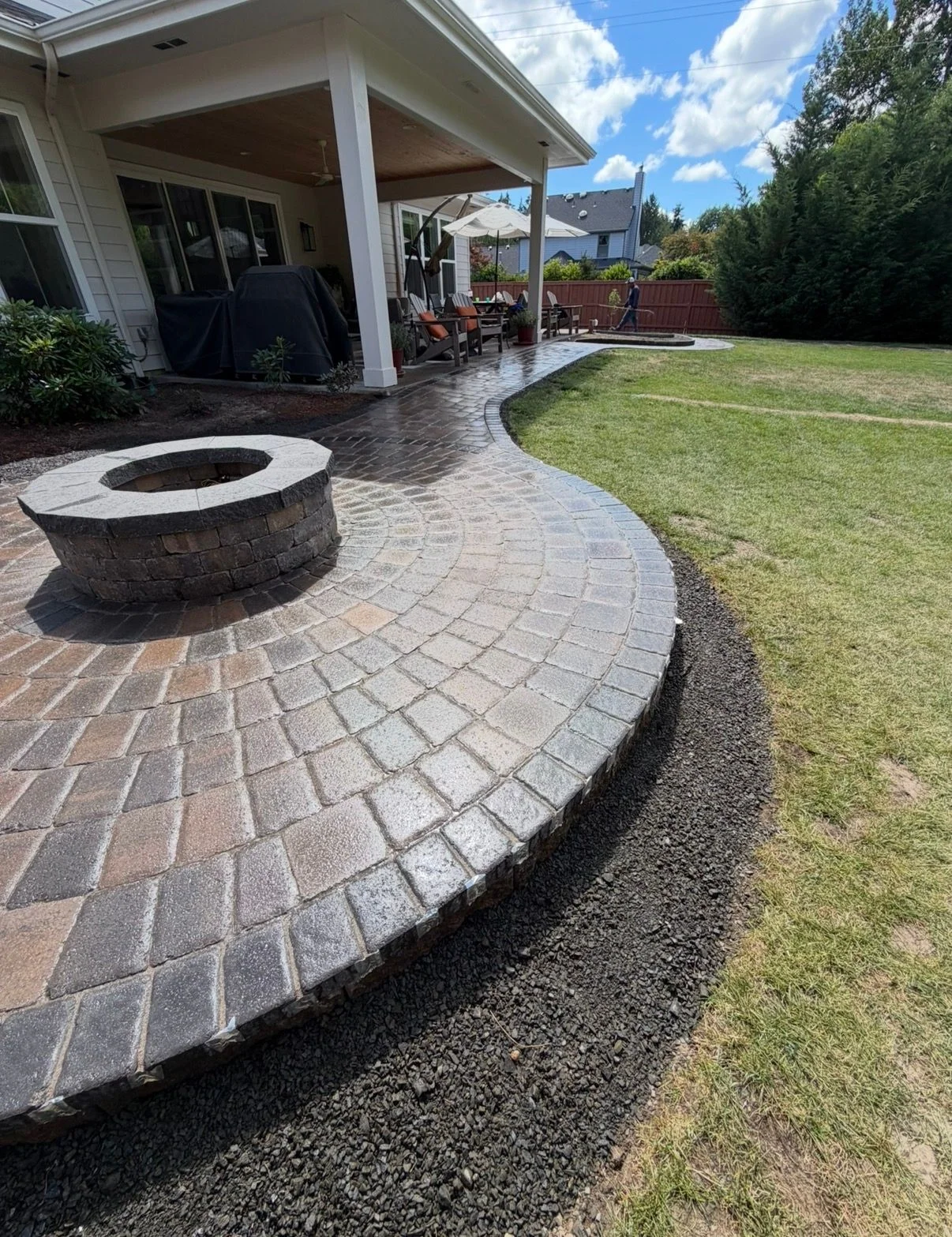 Professional paver patio installation with geometric stone pattern in residential McMinnville, OR backyard