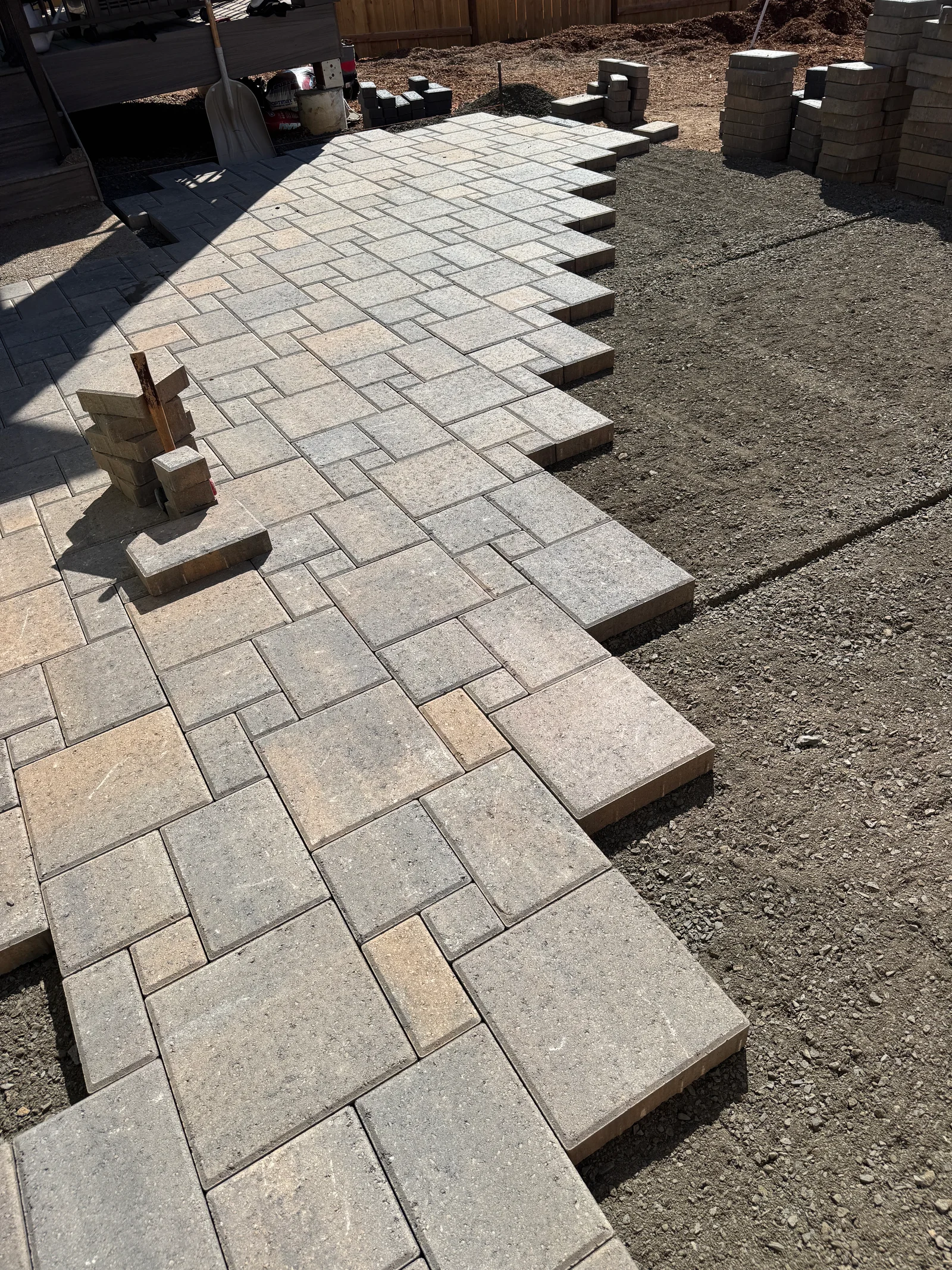 Tumbled concrete pavers in running bond pattern with stepped elevation and gravel base