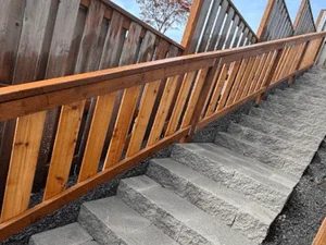 Stamped concrete patio with vertical slat wood railing and natural wood finish